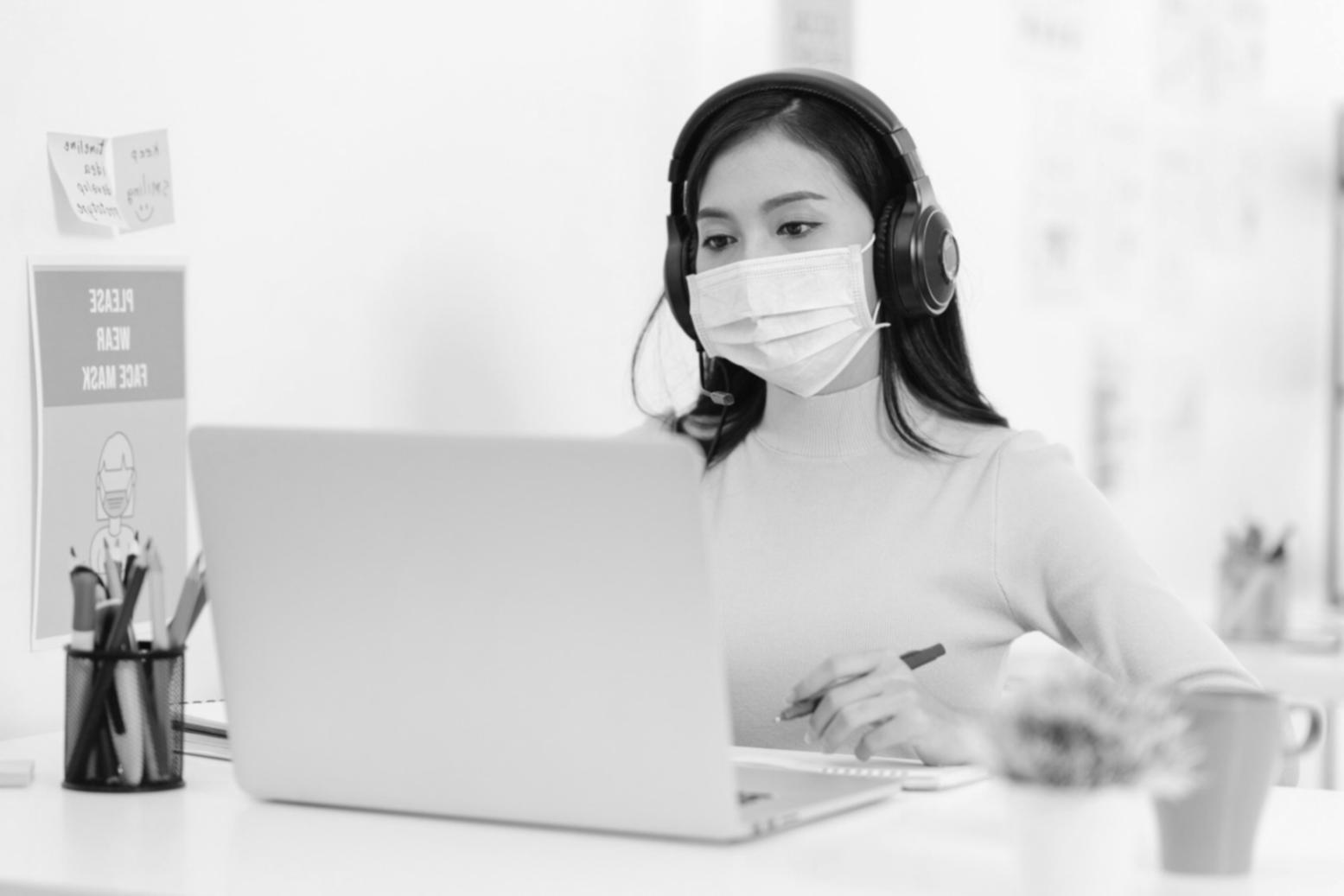 Students collaborating on SEO analytics project with multiple monitors displaying data dashboards